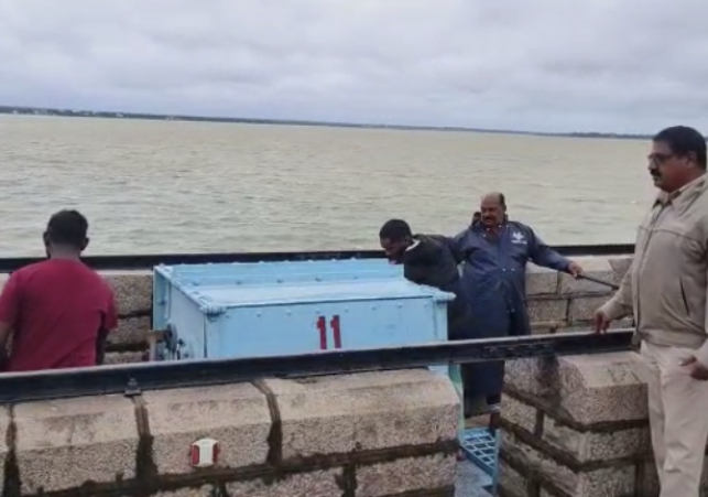 Officials opening crest gates of Osman Sagar on Thursday